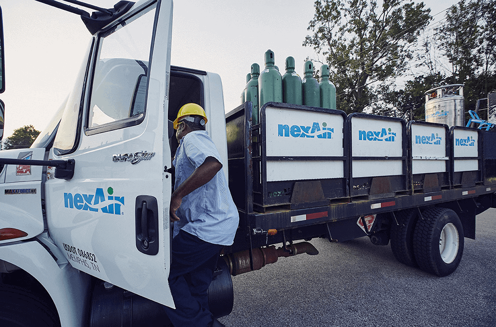 driver preparing gas cylinders for delivery